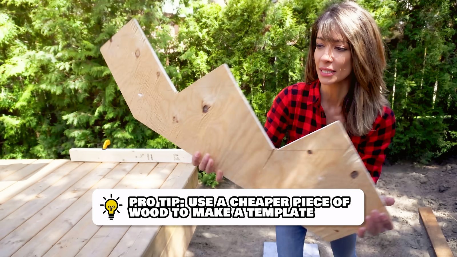 Daru Dhillon holding the full-size plywood deck stair template
