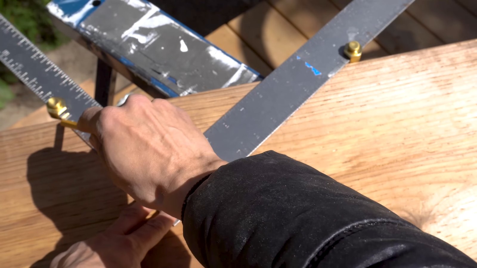 Setting stair gauges on the stringer and tracing the bottom edge of the framing square