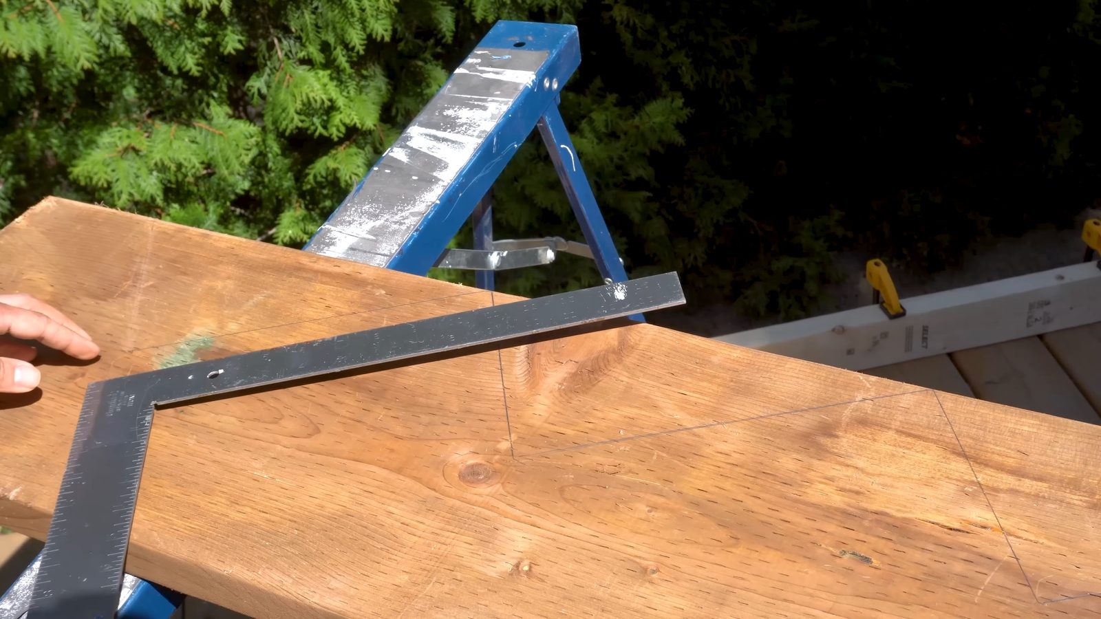 Flipping the framing square to mark the 90 degree line at the top of the stringer