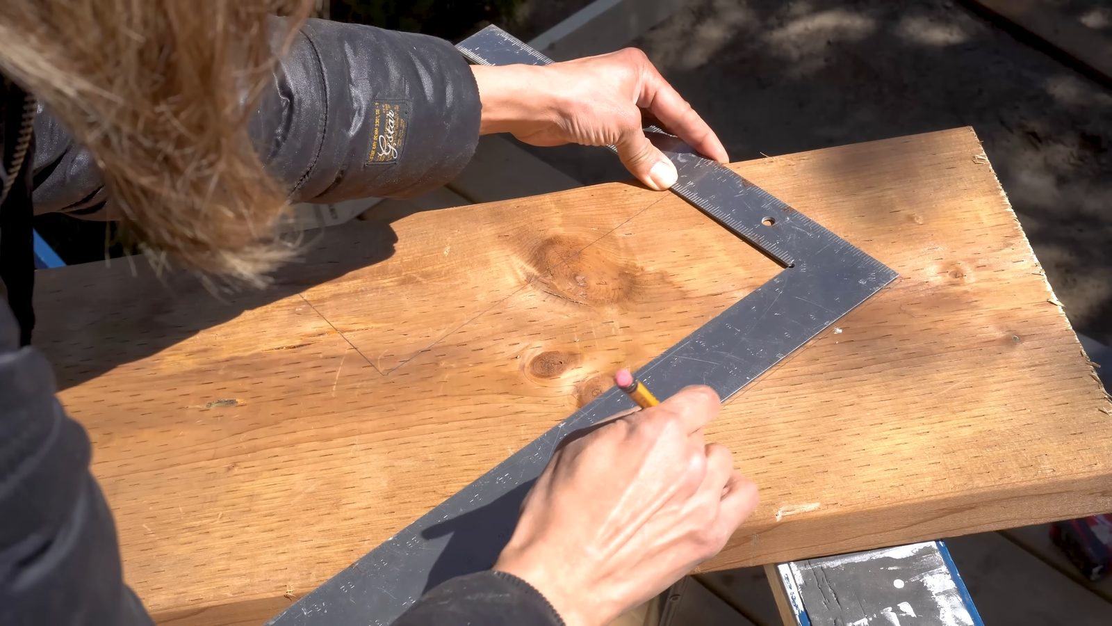 Marking the shortened bottom step of the stringer with a framing square