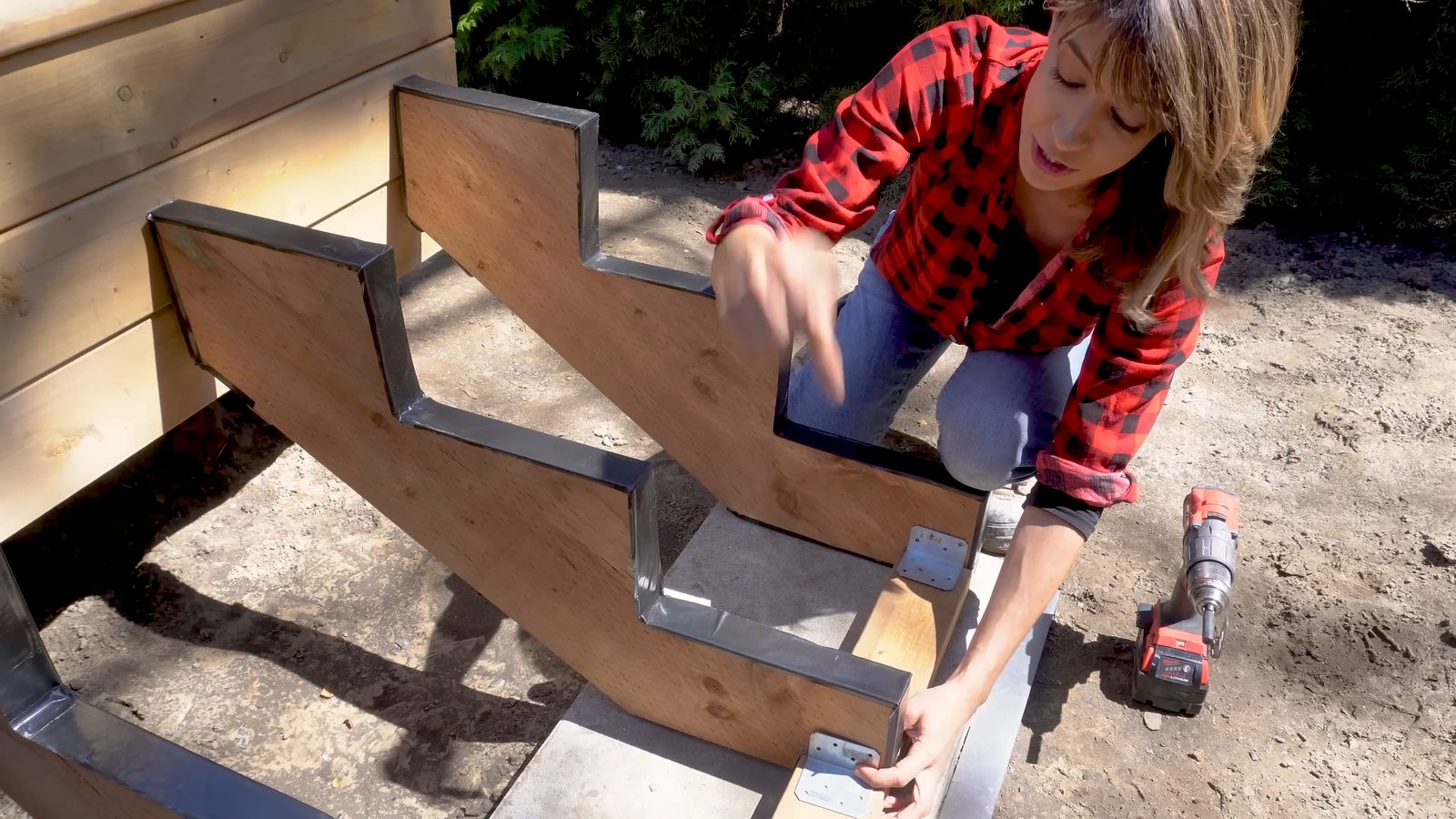 Securing the stringer bases to the 2x4 base plate with angle brackets