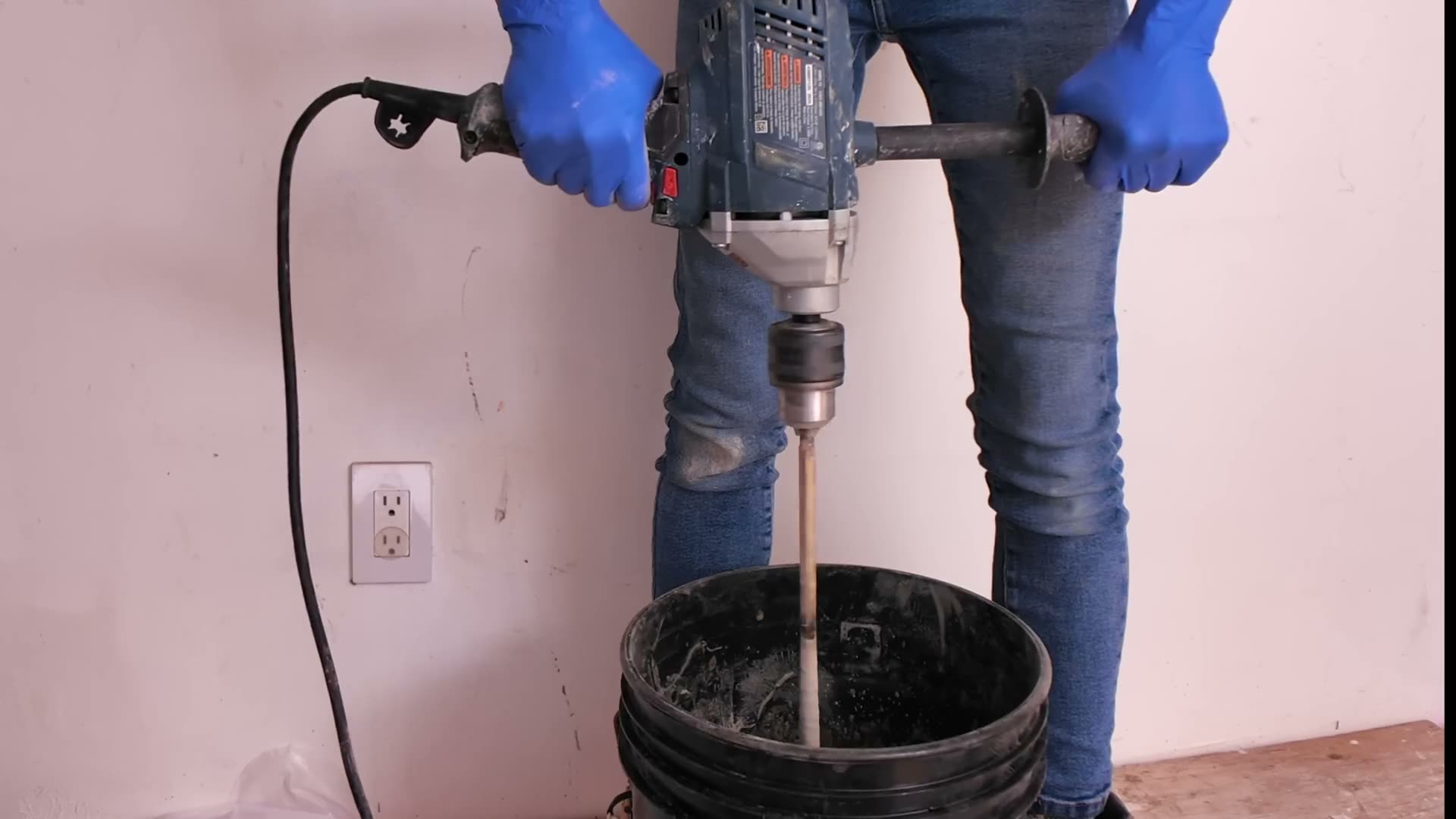 Mixing MAPEI Ultraflex 2 LT modified mortar with a drill and paddle for a tile membrane installation