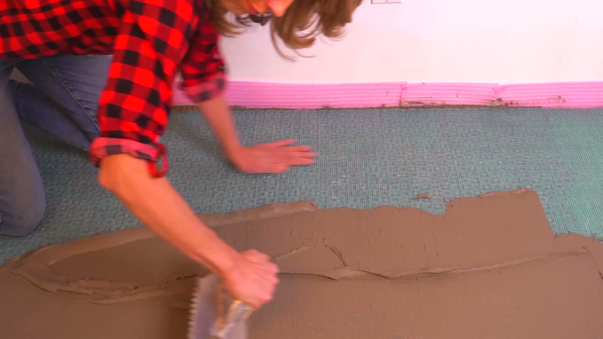 Applying mortar over an installed Mapeguard UM tile membrane so the mesh fabric top layer locks in