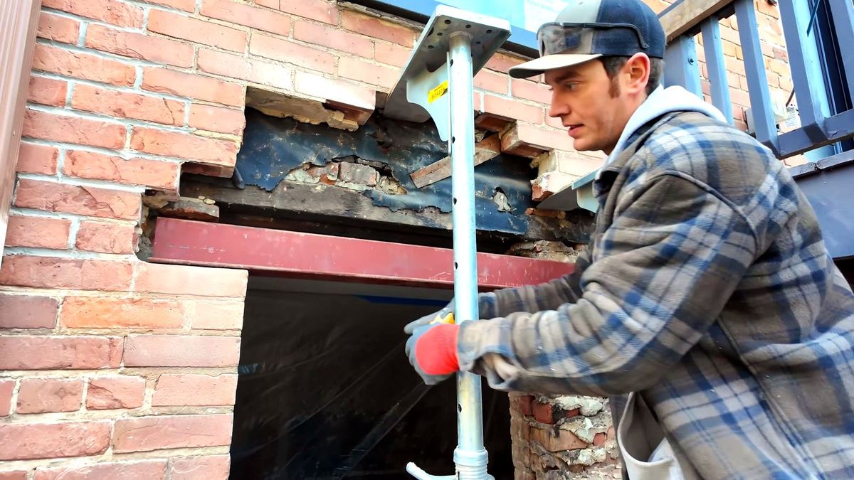 First steel lintel fitted into the opening with strong boy still supporting the brick