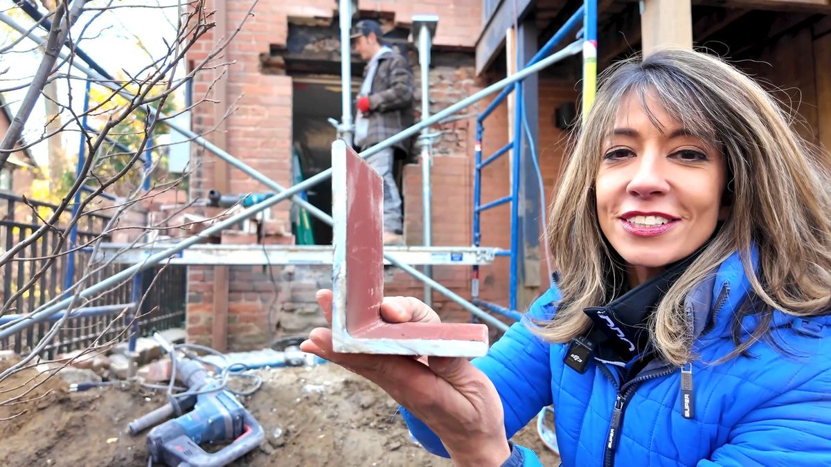 Holding a high-back steel lintel offcut showing the tall vertical back leg