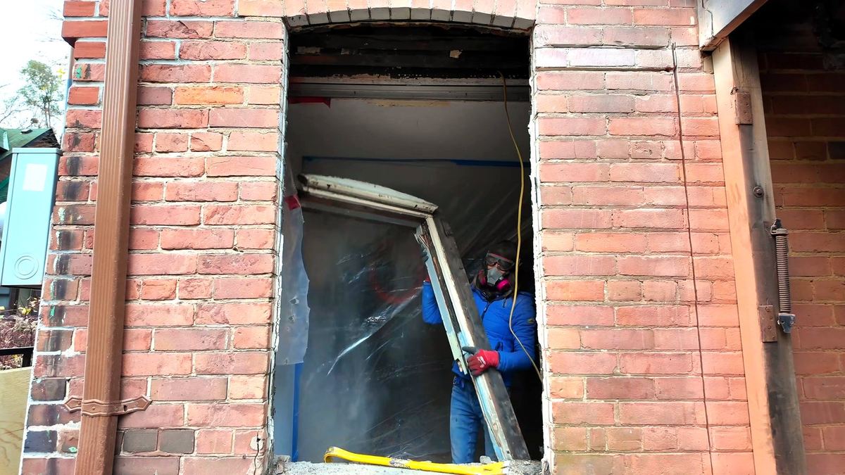 Removing the old window sash from the widened masonry opening