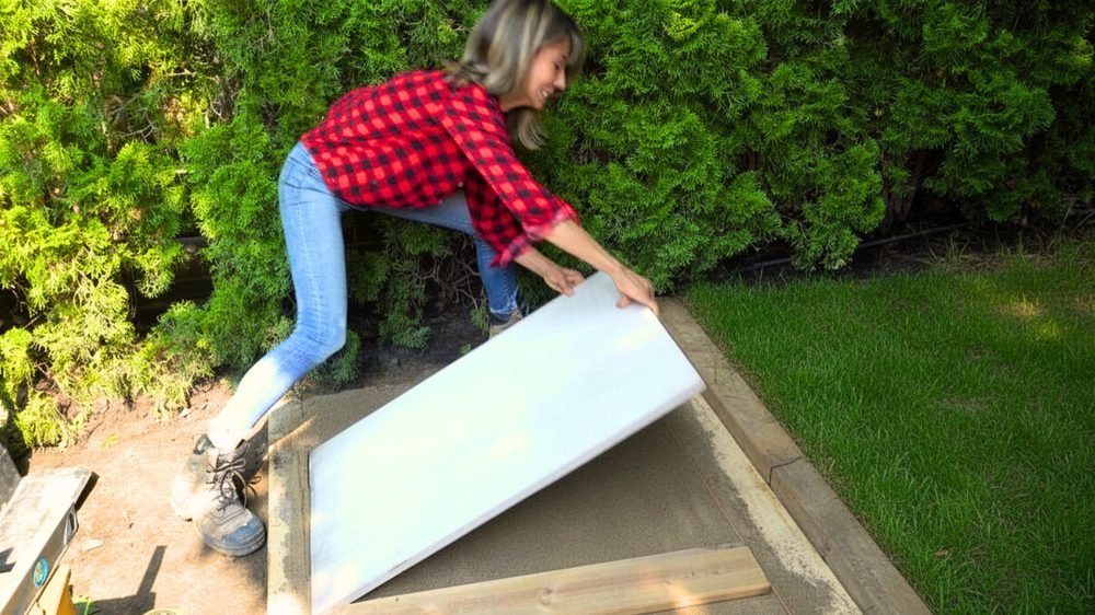 Daru Dhillon setting a large-format paver for a designer walkway